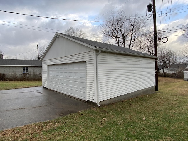 garage featuring a lawn