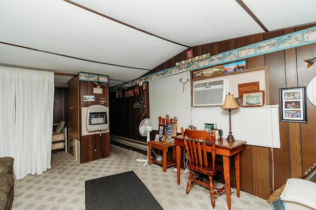 office area featuring vaulted ceiling, an AC wall unit, heating unit, wood walls, and light colored carpet