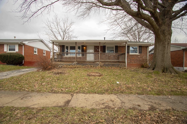 view of front of home with a front yard and covered porch