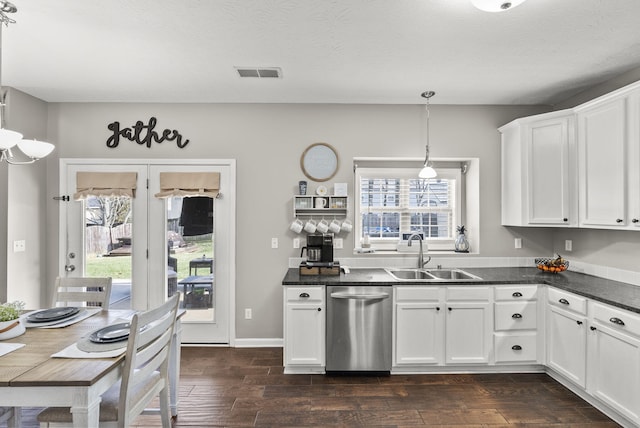 kitchen featuring white cabinetry, sink, and decorative light fixtures