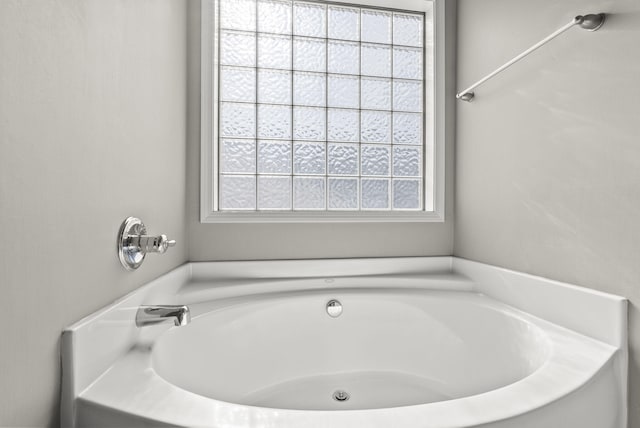 bathroom with a tub to relax in