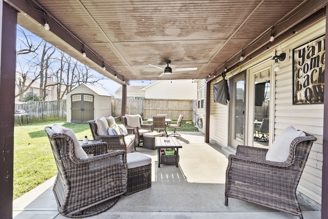 view of patio with outdoor lounge area, ceiling fan, and a storage unit