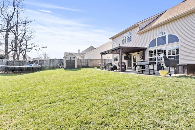 view of yard featuring a shed and a patio