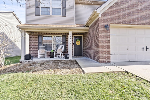 doorway to property with a porch, a garage, and a yard