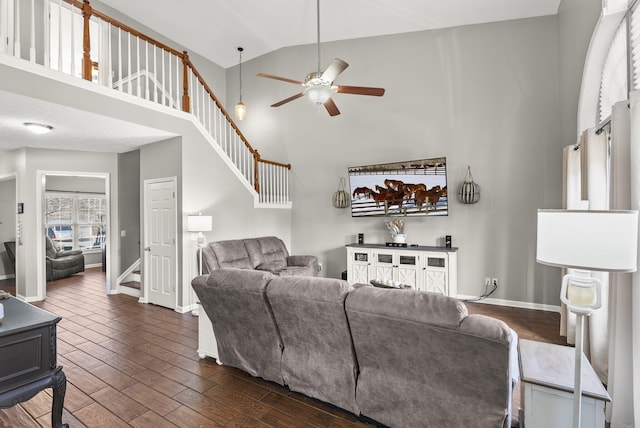 living room featuring dark wood-type flooring, ceiling fan, and high vaulted ceiling