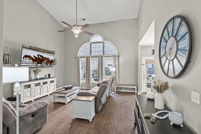 living room with high vaulted ceiling, dark hardwood / wood-style floors, and ceiling fan