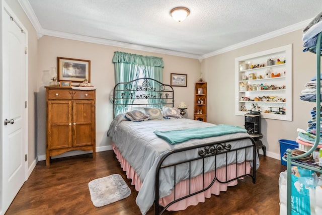 bedroom featuring dark hardwood / wood-style flooring, ornamental molding, and a textured ceiling