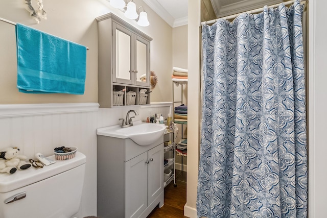 bathroom featuring curtained shower, wood-type flooring, ornamental molding, vanity, and toilet