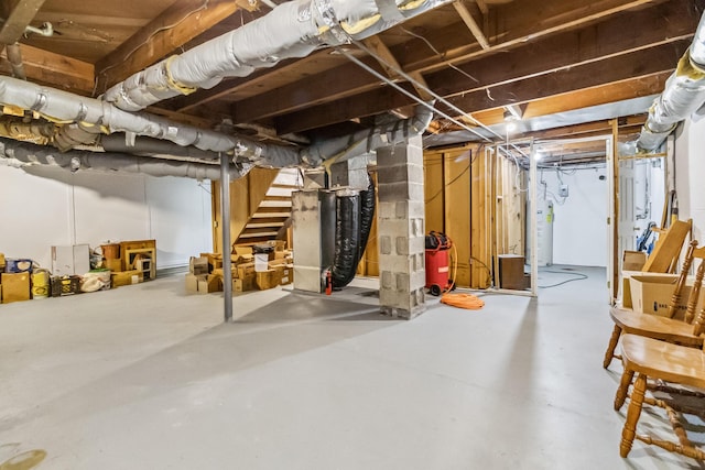 basement featuring water heater and heating unit