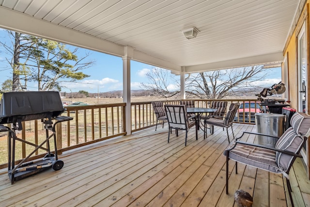 wooden deck featuring a grill