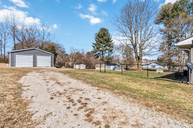 view of yard featuring a garage and an outdoor structure