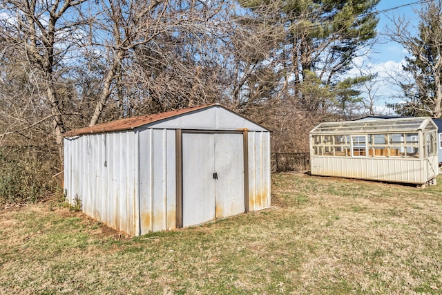 view of outbuilding featuring a yard