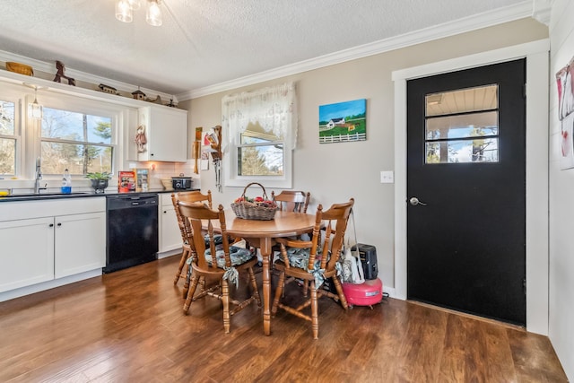 dining area featuring dark hardwood / wood-style flooring, sink, crown molding, and a wealth of natural light