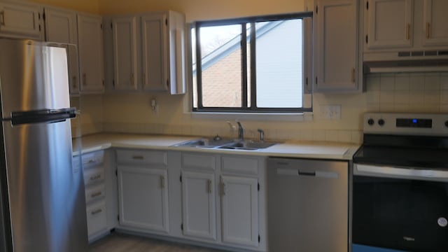 kitchen featuring white cabinetry, a healthy amount of sunlight, stainless steel appliances, and sink