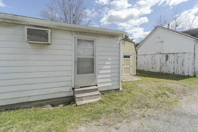view of outbuilding with a wall mounted air conditioner and entry steps