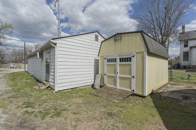 view of shed featuring fence