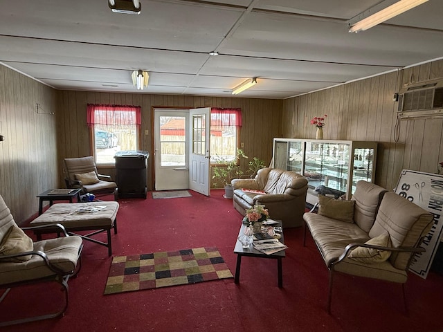 living room featuring an AC wall unit and carpet floors