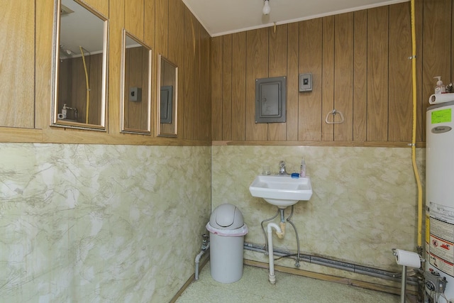 bathroom featuring water heater, a sink, and electric panel