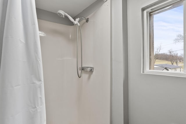 bathroom featuring plenty of natural light and walk in shower