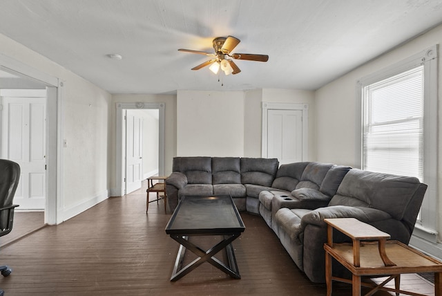 living room with dark hardwood / wood-style flooring and ceiling fan