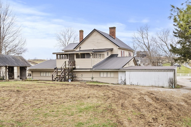 rear view of property featuring a sunroom