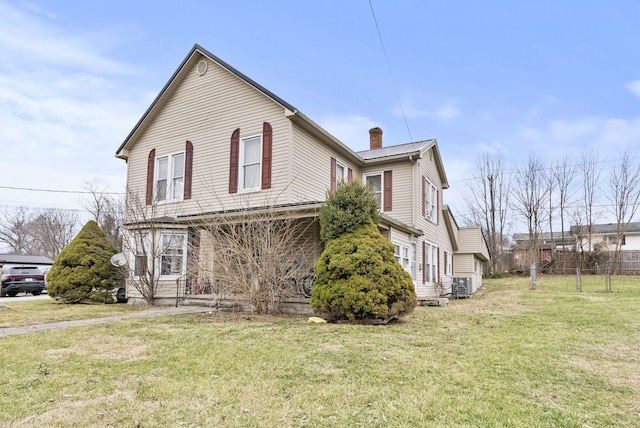 view of front of house featuring central AC and a front lawn