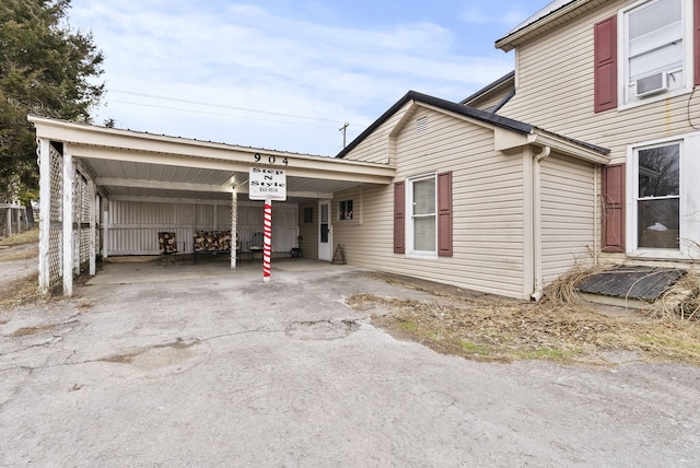 view of front facade with a carport and cooling unit