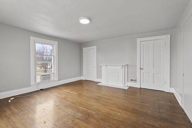 unfurnished room featuring dark wood-type flooring and cooling unit