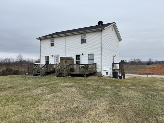 rear view of house with a wooden deck, a yard, and cooling unit