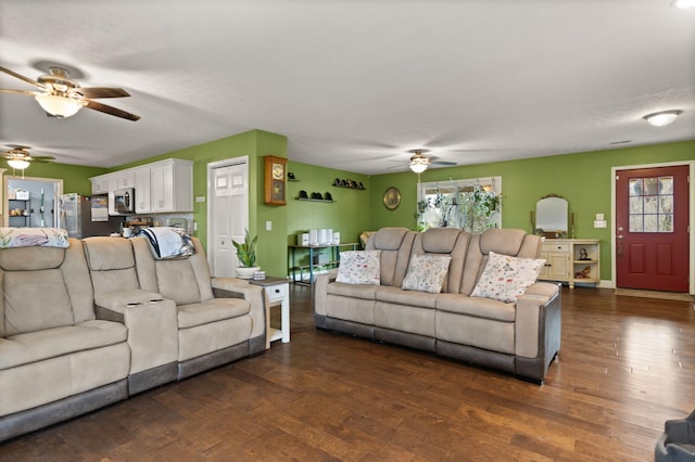 living room featuring ceiling fan and dark hardwood / wood-style floors