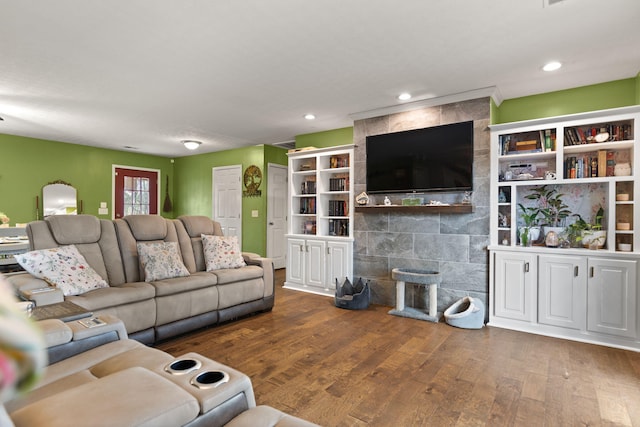 living room with dark hardwood / wood-style flooring and a tile fireplace