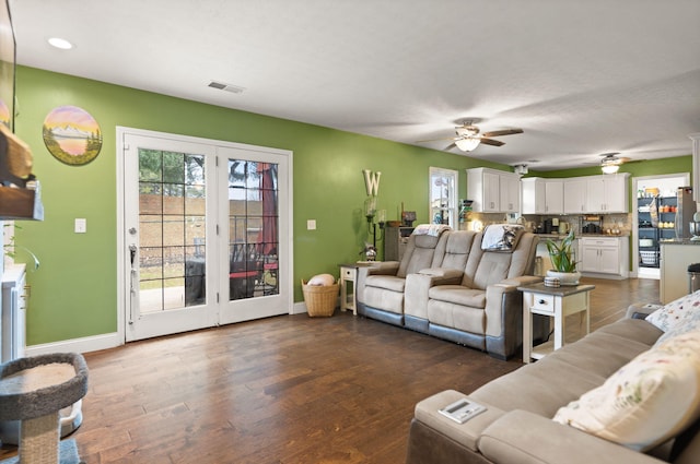 living room featuring dark hardwood / wood-style floors and ceiling fan