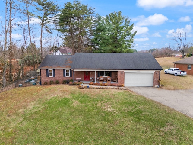 ranch-style house with a garage, covered porch, and a front lawn