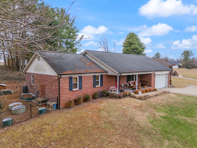 exterior space with a garage, covered porch, and a front lawn