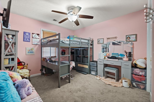 carpeted bedroom featuring a textured ceiling and ceiling fan