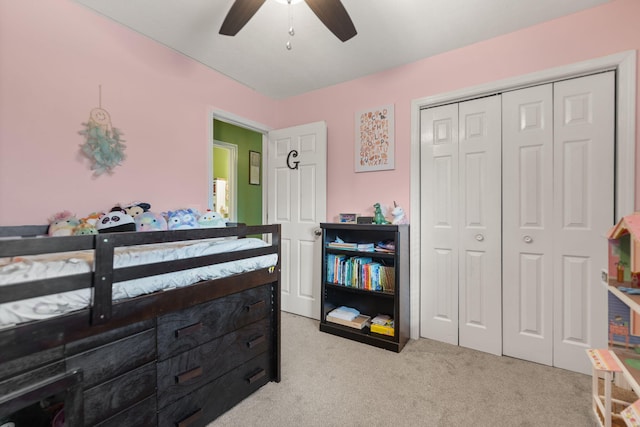 carpeted bedroom with ceiling fan and a closet