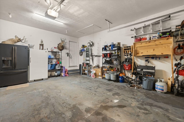 garage with a garage door opener, black fridge with ice dispenser, and white refrigerator