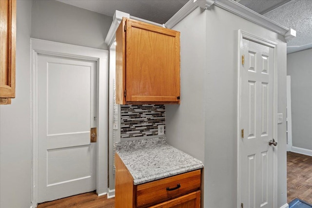 kitchen with backsplash and light hardwood / wood-style flooring