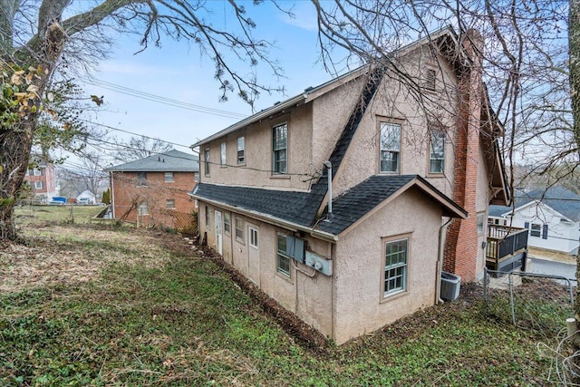 view of side of home with central AC