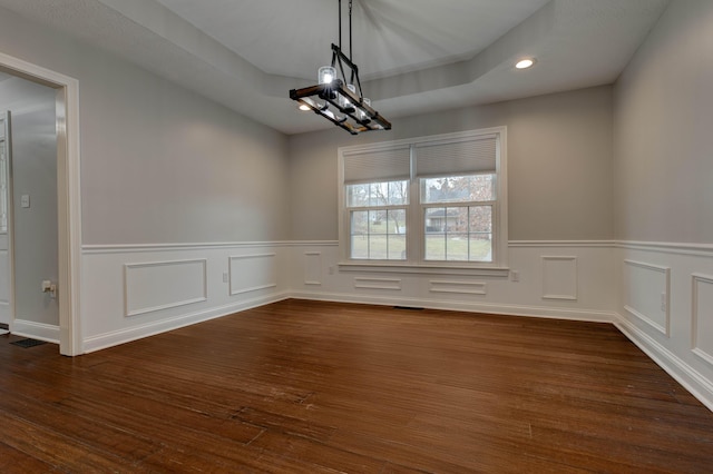 unfurnished dining area featuring dark hardwood / wood-style floors and a notable chandelier