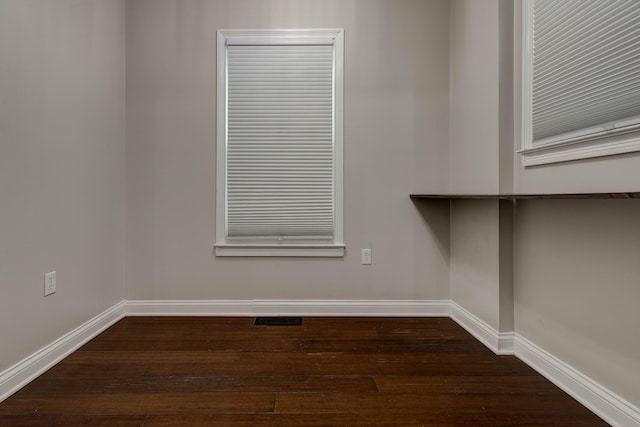 unfurnished room featuring dark hardwood / wood-style flooring