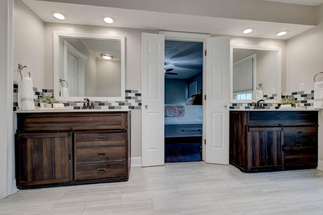 bathroom featuring vanity and tasteful backsplash