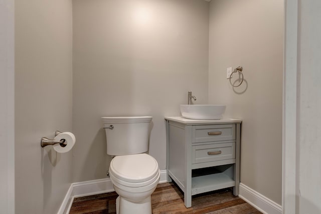 bathroom with vanity, toilet, and wood-type flooring