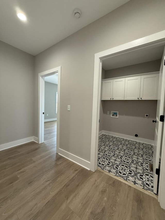 laundry area featuring cabinets, washer hookup, hookup for an electric dryer, and wood-type flooring