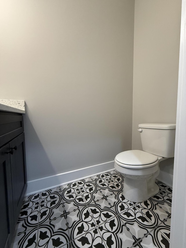 bathroom with vanity, tile patterned floors, and toilet