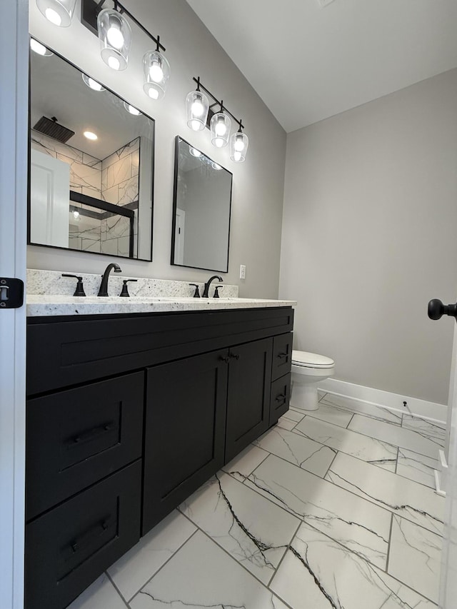 bathroom with vanity, a shower with shower door, and toilet