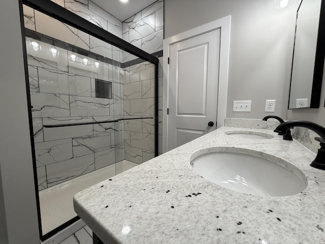 bathroom featuring vanity and an enclosed shower