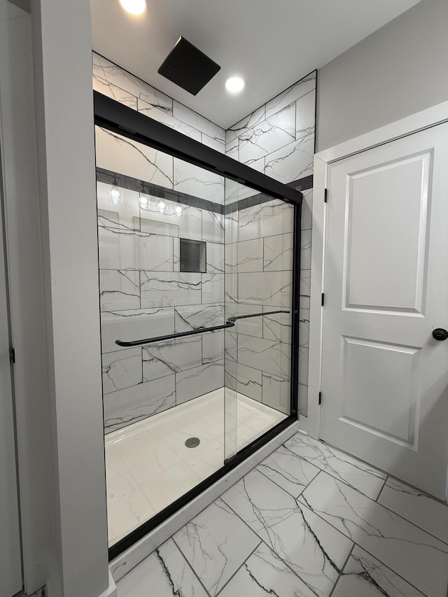 bathroom with a shower with shower door