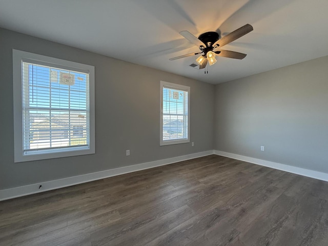 empty room featuring dark hardwood / wood-style floors and ceiling fan