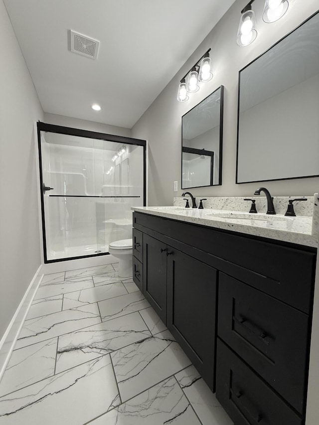 bathroom featuring vanity, toilet, and an enclosed shower